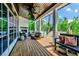 Expansive outdoor porch with fireplace, ceiling fan and comfortable seating at 103 Park Ave, Anna Maria, FL 34216
