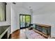 Versatile room featuring dark wood floors, stylish cabinet, area rug, and french doors leading to covered outdoor porch at 103 Park Ave, Anna Maria, FL 34216