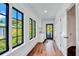 Bright and airy room with dark wood floors, white cabinets, and multiple windows offering scenic views of the outside at 103 Park Ave, Anna Maria, FL 34216