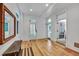 Bright room with wooden floors, with windows and doorways to more light at 103 Park Ave, Anna Maria, FL 34216