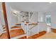 Well-lit staircase with hardwood steps and white railings leading to the upstairs area of the home at 103 Park Ave, Anna Maria, FL 34216