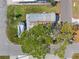 Aerial view of a property featuring a trailer and a tree-shaded roof in a sunny neighborhood at 10315 Cortez W Rd # 24-5, Bradenton, FL 34210