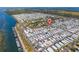 Community aerial view, highlighted by marker, with waterfront location, meticulously maintained homes and lush landscaping at 10315 Cortez W Rd # 24-5, Bradenton, FL 34210
