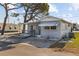 Single-story home showcasing its covered entry and paved driveway, highlighting outdoor appeal at 10315 Cortez W Rd # 24-5, Bradenton, FL 34210