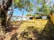 View of the house from the fenced backyard with a shed and covered patio, offering privacy and space at 1142 Newhope Rd, Spring Hill, FL 34606