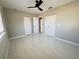 A bedroom with tile floors, ceiling fan and two closets offers a clean and modern living space at 1142 Newhope Rd, Spring Hill, FL 34606