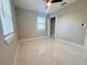 A bedroom with tiled floors, a window letting in natural light, and a closet provides a comfortable retreat at 1142 Newhope Rd, Spring Hill, FL 34606