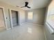 Cozy bedroom featuring a ceiling fan, tile floor, and natural light at 1142 Newhope Rd, Spring Hill, FL 34606