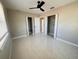 Spacious bedroom with tile floors, ceiling fan, and double closets at 1142 Newhope Rd, Spring Hill, FL 34606