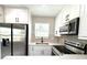 Well-appointed kitchen with stainless steel appliances and white cabinetry at 1142 Newhope Rd, Spring Hill, FL 34606