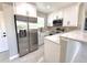 Modern kitchen featuring stainless steel appliances, stone counters, and white cabinets at 1142 Newhope Rd, Spring Hill, FL 34606