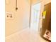 Bright laundry room with tile flooring and access to other rooms, with water heater visible at 1142 Newhope Rd, Spring Hill, FL 34606
