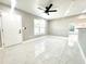 Bright living room with new tile floors, ceiling fan and fresh paint at 1142 Newhope Rd, Spring Hill, FL 34606