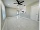 Open-concept living room and kitchen with new tile floors and fresh paint at 1142 Newhope Rd, Spring Hill, FL 34606