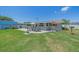 The backyard features an outdoor patio with seating area and views of the lawn at 130 E Seminole Dr, Venice, FL 34293