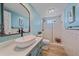 Modern bathroom featuring vessel sink, large mirror and sleek glass shower with tile accents at 130 E Seminole Dr, Venice, FL 34293