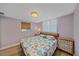 Bright bedroom features a wood frame bed with stylish coral-themed bedding and wood floors at 130 E Seminole Dr, Venice, FL 34293