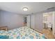 This bedroom features tile floors, lilac walls, and a walk-in bathroom at 130 E Seminole Dr, Venice, FL 34293