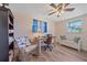 Bright home office with a ceiling fan, blue curtains, and beach-themed decor, a perfect workspace at 130 E Seminole Dr, Venice, FL 34293