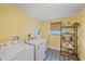 Functional laundry room with modern washer and dryer and decorative shelving at 130 E Seminole Dr, Venice, FL 34293