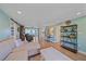 Open-concept living room with wood-look floors and neutral furniture, providing a warm and inviting space at 130 E Seminole Dr, Venice, FL 34293