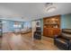 Comfortable living area with wood-look tile flooring, light blue walls and lots of natural light at 130 E Seminole Dr, Venice, FL 34293
