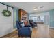 Inviting living room featuring wood floors, modern recliners, and built in wood cabinet at 130 E Seminole Dr, Venice, FL 34293