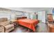 Inviting bedroom with a comfortable bed, reading chair, and ample natural light from the window at 1307 41St E Ave, Ellenton, FL 34222