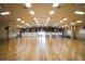 Spacious community center ballroom with wood floors and tables and chairs at 1307 41St E Ave, Ellenton, FL 34222