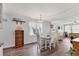 The dining area features four seats, lots of light from the sheer curtains, and light blue walls at 1307 41St E Ave, Ellenton, FL 34222