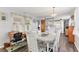 Charming dining area with desk and light blue walls with an opening to the kitchen at 1307 41St E Ave, Ellenton, FL 34222