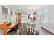 Charming dining area with desk and light blue walls with an opening to the kitchen at 1307 41St E Ave, Ellenton, FL 34222