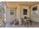 Cozy entrance featuring a covered porch, table, and charming welcome mat at 1307 41St E Ave, Ellenton, FL 34222