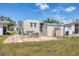 Exterior of the home with patio and storage shed overlooking the lawn at 1307 41St E Ave, Ellenton, FL 34222