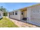 Charming home exterior featuring a lattice-covered porch and tidy landscaping at 1307 41St E Ave, Ellenton, FL 34222