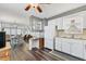 Cozy kitchen featuring white cabinets, modern appliances, wood-look flooring, and convenient built-in desk space at 1307 41St E Ave, Ellenton, FL 34222