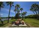 Enjoy a picnic on this park bench with a lakeside view surrounded by mature palms at 1307 41St E Ave, Ellenton, FL 34222