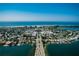 Beautiful aerial view of a coastal community with waterfront homes and easy access to the beach and waterways at 135 Grant Dr, Sarasota, FL 34236