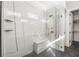 Modern bathroom featuring a tiled shower with a bench, rainfall showerhead, and glass enclosure at 135 Grant Dr, Sarasota, FL 34236