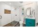 Modern bathroom featuring a glass shower, wood accent wall, and stylish vanity with sleek fixtures and colorful decor at 135 Grant Dr, Sarasota, FL 34236