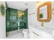 Stylish bathroom featuring green-tiled shower and gold hardware at 135 Grant Dr, Sarasota, FL 34236
