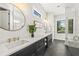 Spacious bathroom with dual vanities, stylish mirrors, and a glass-enclosed shower at 135 Grant Dr, Sarasota, FL 34236