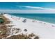 Expansive beach view with white sand, clear water, and people enjoying the sun and surf at 135 Grant Dr, Sarasota, FL 34236