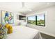 Bright bedroom with a large window view, ceiling fan, wall-mounted TV, and stylish decor at 135 Grant Dr, Sarasota, FL 34236