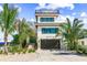 Stunning contemporary home with a rooftop deck, lush tropical landscaping, and an attached two-car garage at 135 Grant Dr, Sarasota, FL 34236