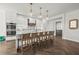 Modern kitchen featuring white cabinetry, stainless steel appliances, and an island with bar seating at 135 Grant Dr, Sarasota, FL 34236