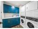 Laundry room featuring a washer, dryer, with upper and lower cabinets and counter at 135 Grant Dr, Sarasota, FL 34236