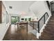 Spacious open layout offering seamlessly integrated kitchen, dining, and living spaces with modern stair case at 135 Grant Dr, Sarasota, FL 34236