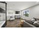 Cozy living room features a comfortable gray sofa, a window, and an entertainment center at 135 Grant Dr, Sarasota, FL 34236
