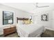 Bedroom with a white bed, ceiling fan, and window with plantation blinds at 135 Grant Dr, Sarasota, FL 34236